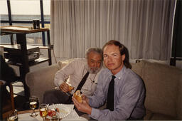 Men eat sandwiches at conference, March 1990.