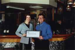 People pose with novelty cheque, circa 1990s.
