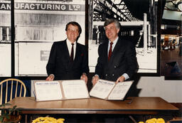 Two men pose with Emily Carr documents, circa 1990s.