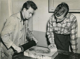Two men work in printing studio, date unknown.