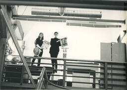 Students hold up print material, circa 1990s.