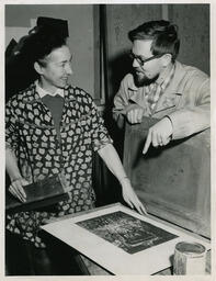 Students or faculty discuss silkscreening, date unknown.