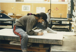 Student working on 2000lb stone block, circa 1990s.