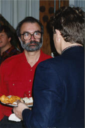 Men talk at event, circa 1990s.