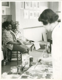 Student painting fellow student sitting down, circa 1960s.