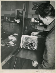 Student flips through book, VSB design students D series, 1954.