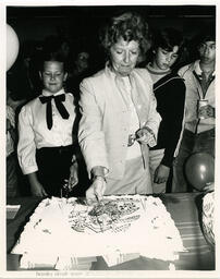 Candles lit on cake for BCYA opening, 1983.