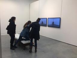 Training videos at opening reception, audience interacting with the bench
