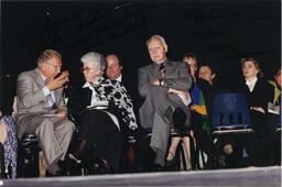 People sit on stage, circa 1990s.