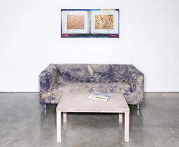 Manual, presented with props (couch, coffee table, painting-­like object)