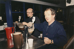 [Staff members?] pull pitchers of beer, circa 1990s.
